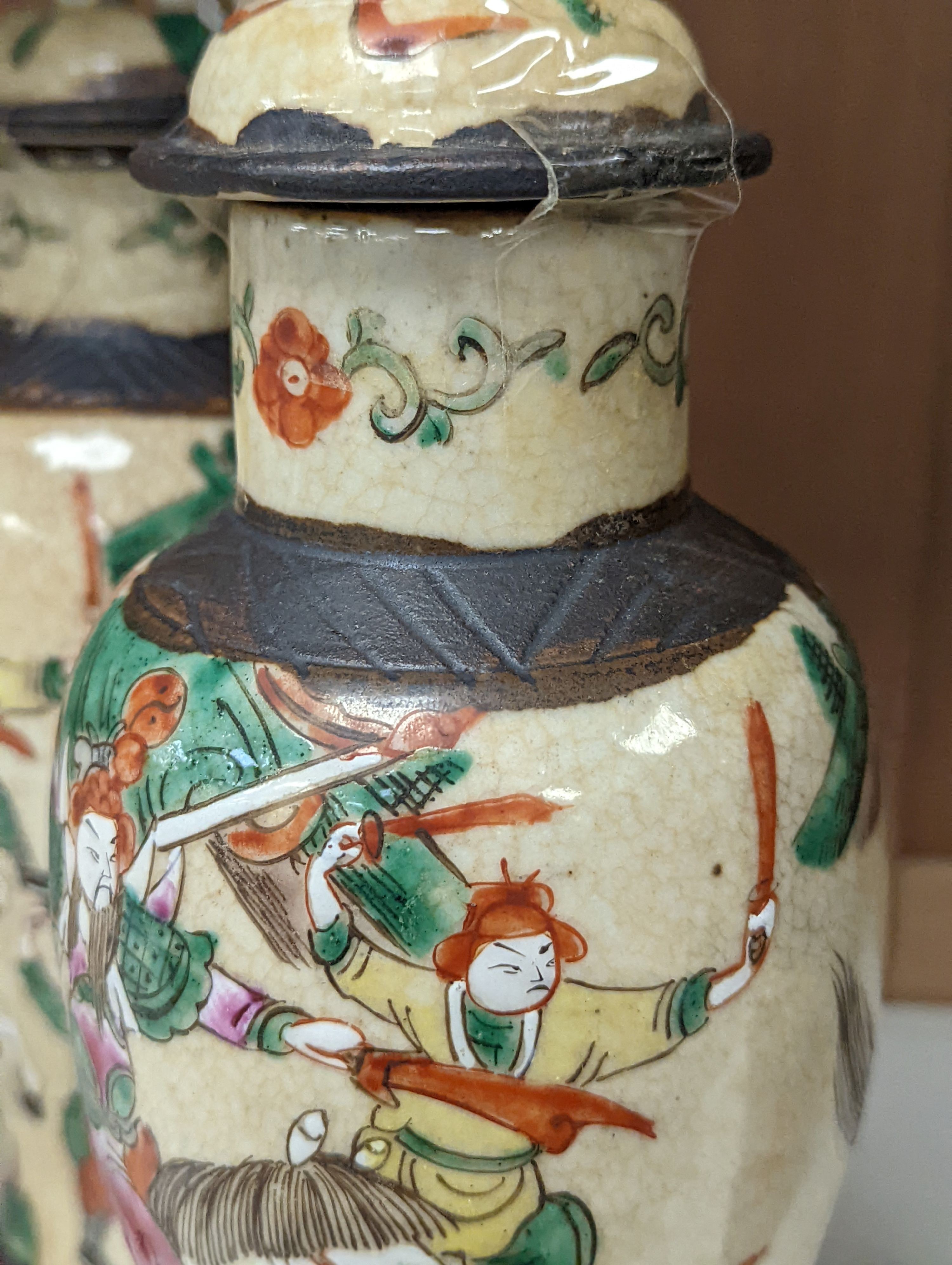 A pair of Chinese famille rose crackle glaze baluster jars and covers, 27cm.